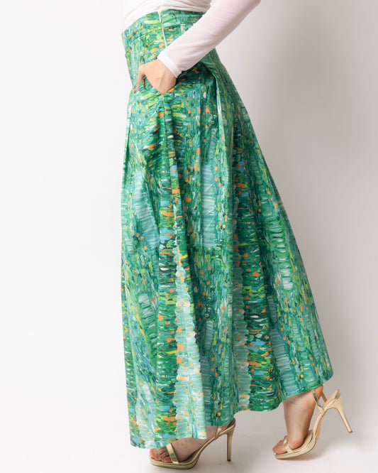 Person wearing a green patterned skirt on a white background