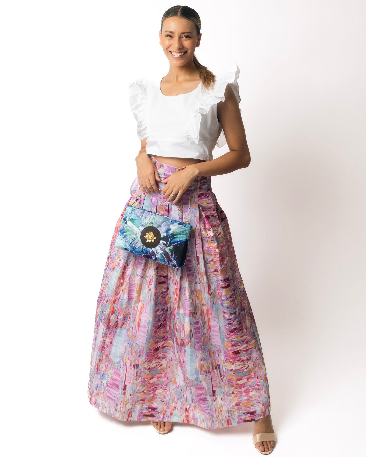 Woman wearing a pink colorful skirt against a white background