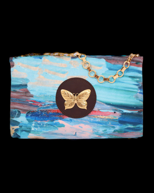 Clutch bag with brass butterfly accent