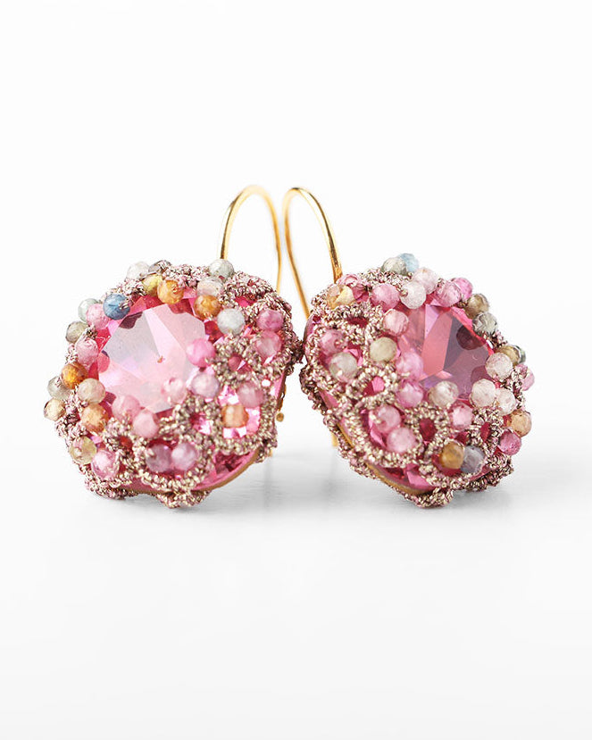 A pair of pink tourmaline earrings with gold-plated hooks and lacework, featuring glass beads.