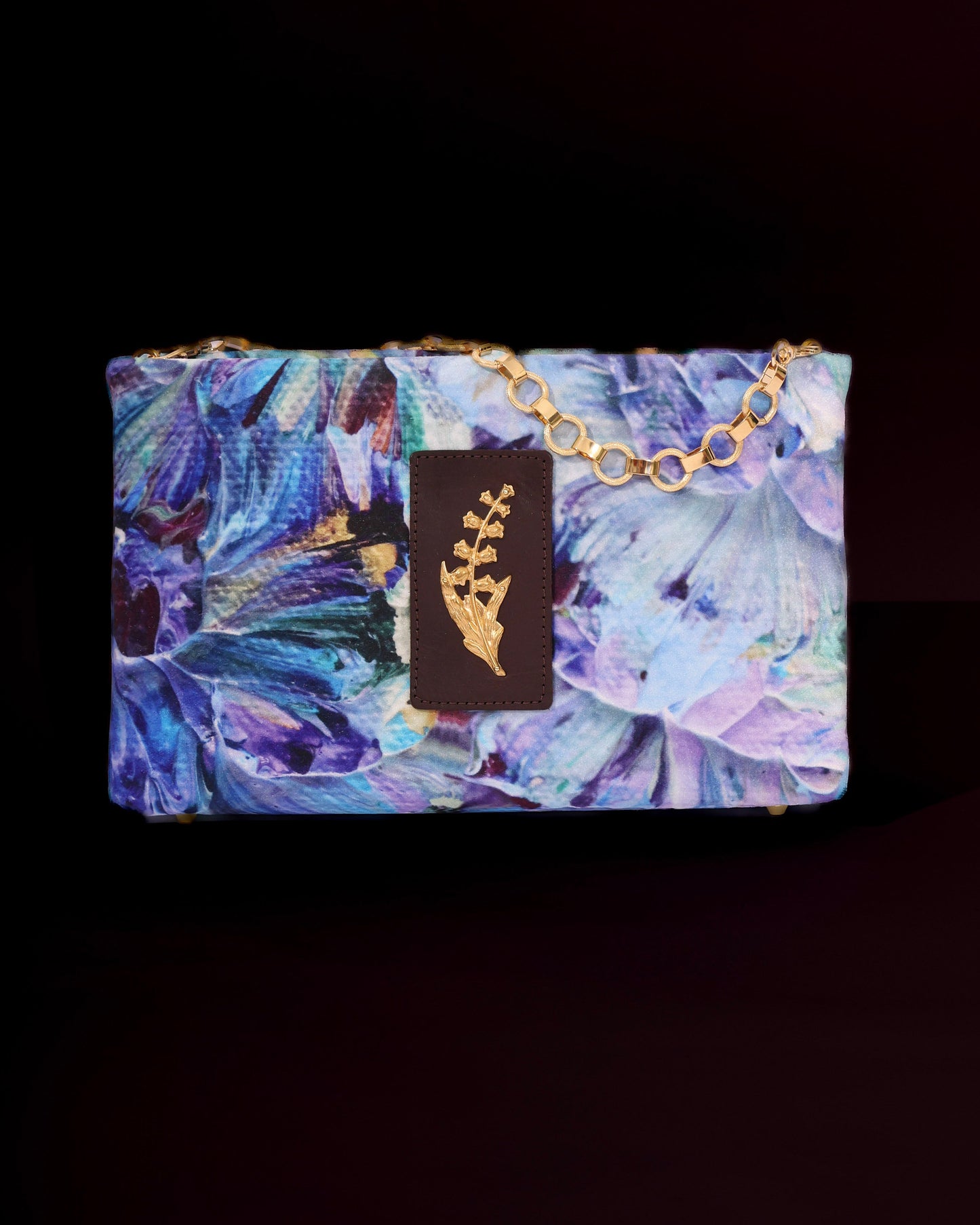Floral-patterned clutch bag with sprig brass accent