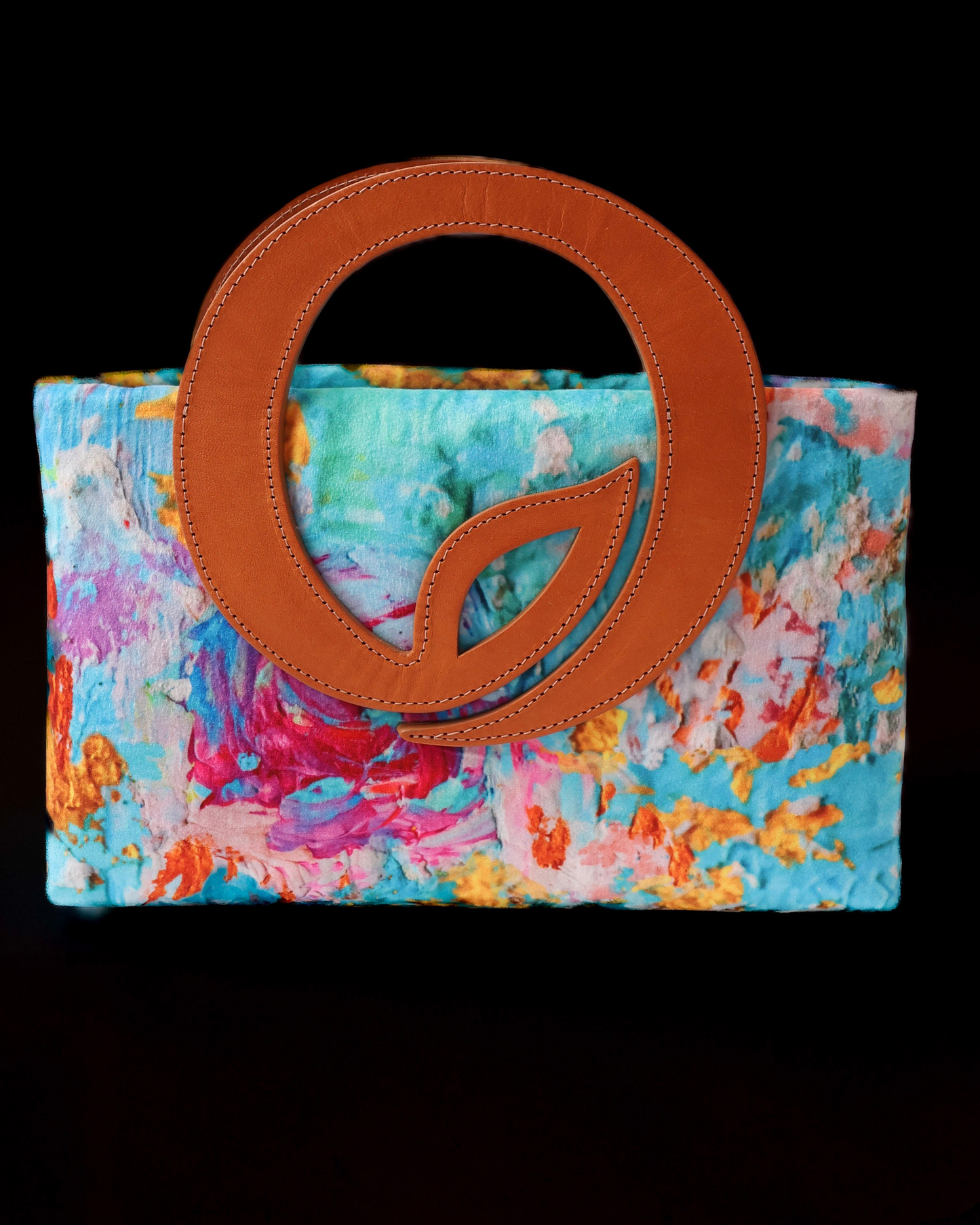 Colorful handbag with a brown leather leaf handle