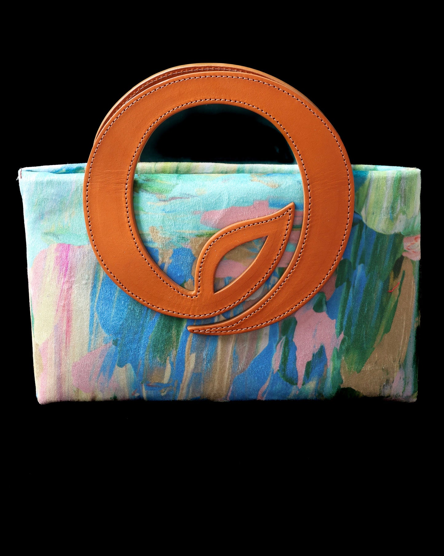 Handbag with a colorful watercolor pattern and caramel circular leaf handle